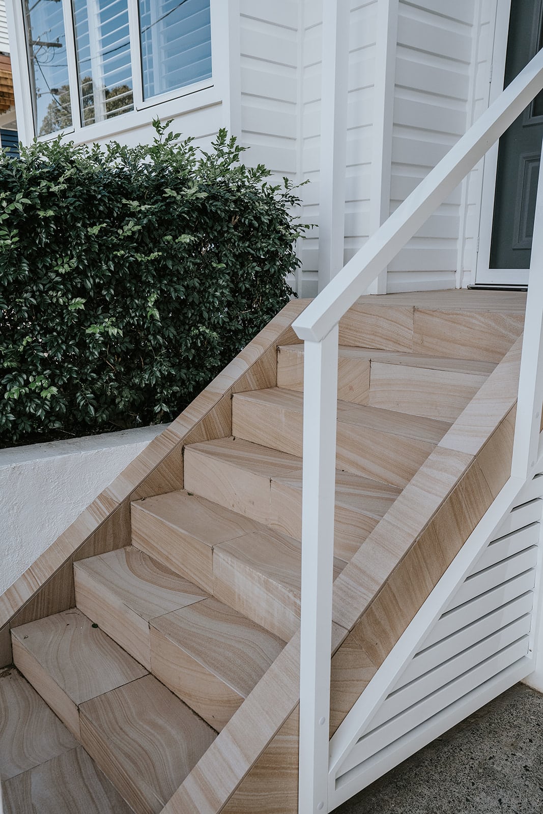 Entryway sandstone stairs with powder coated railing 