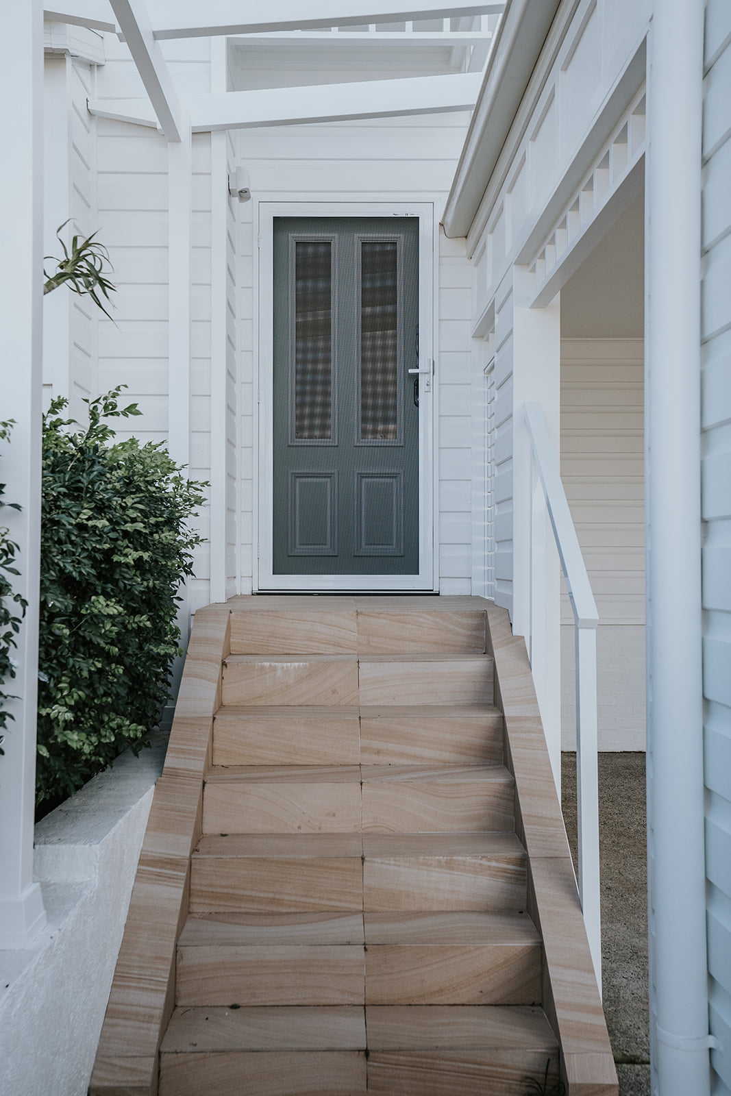 Entryway sandstone stairs with powder coated railing 