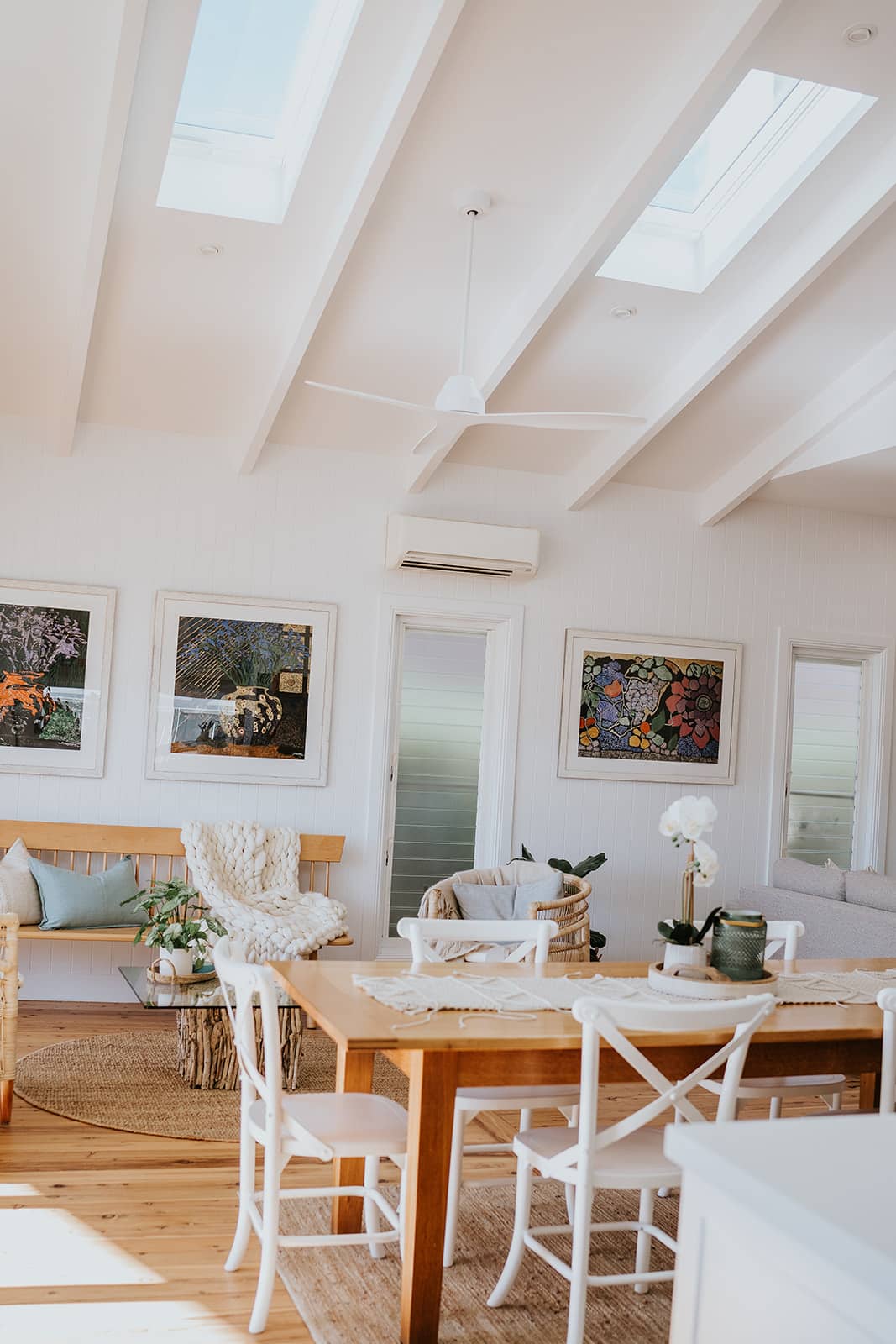 Open plan living and dining area coastal hamptons style raked ceilings with exposed rafters