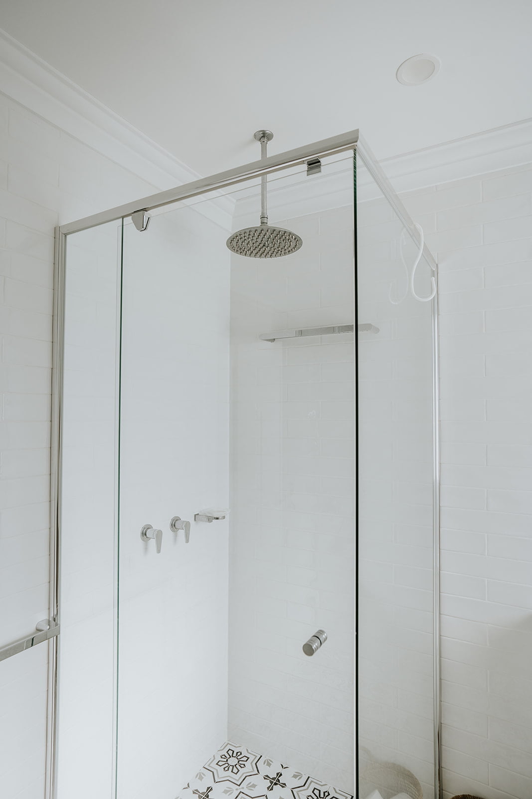 custom semi-frameless shower screen with satin chrome shower head and mixers