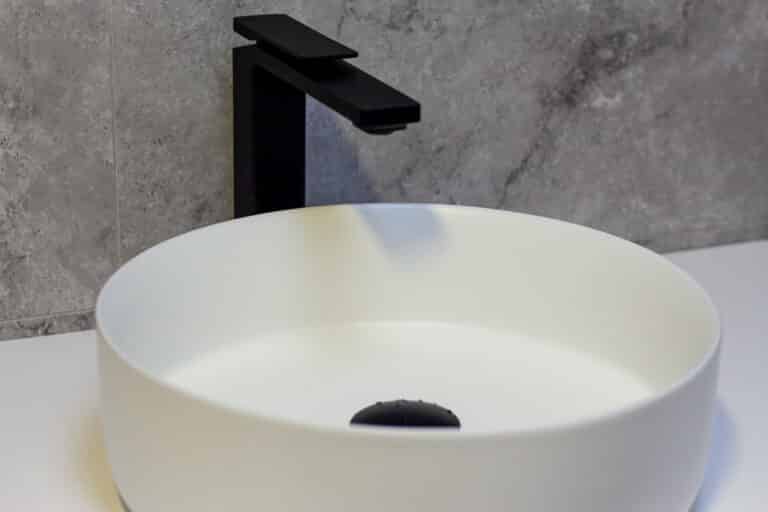 Round benchtop basin with matt black tapware